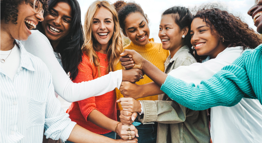 6 women with their hands together