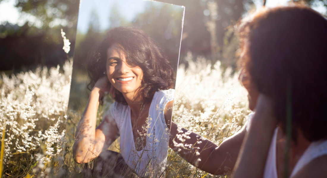 Woman looking at herself in a mirror
