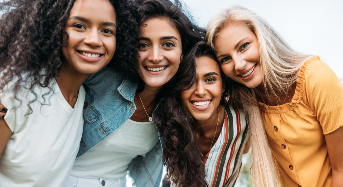 4 women smiling together