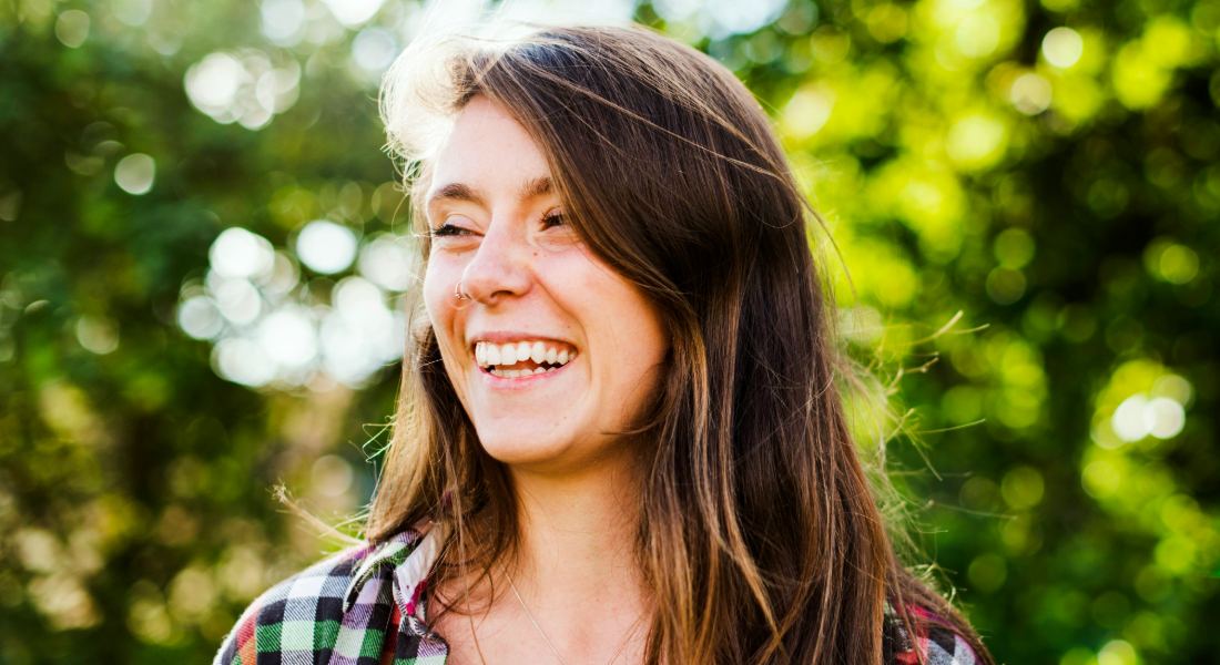 Candid, smiling photo of young woman